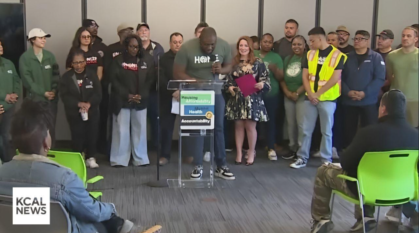 Image of man speaking and group of people listening