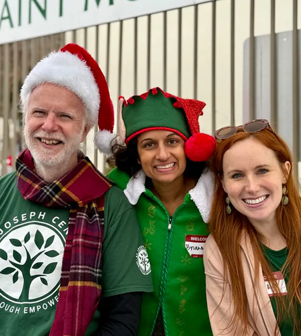 A group of St. Joseph Center volunteers dressed up at a Christmas event.