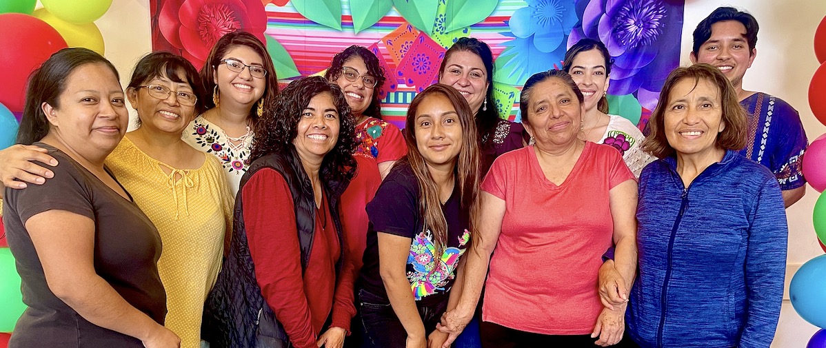 IMage of group of women in colorful clothing smiling