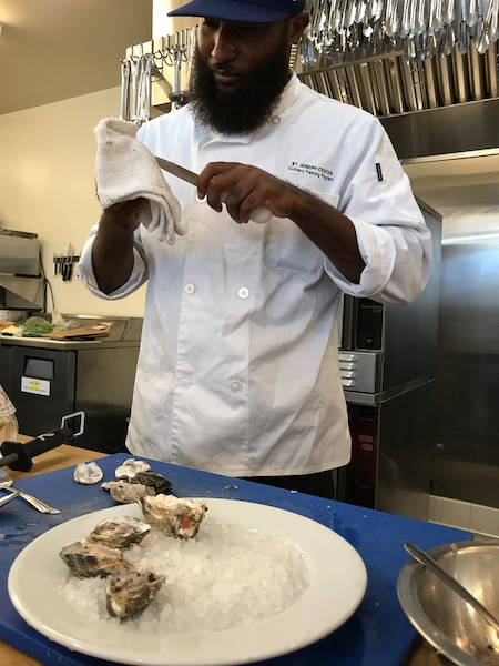 Male chef cleaning his knife