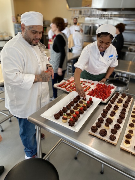 Chefs arranging pastries