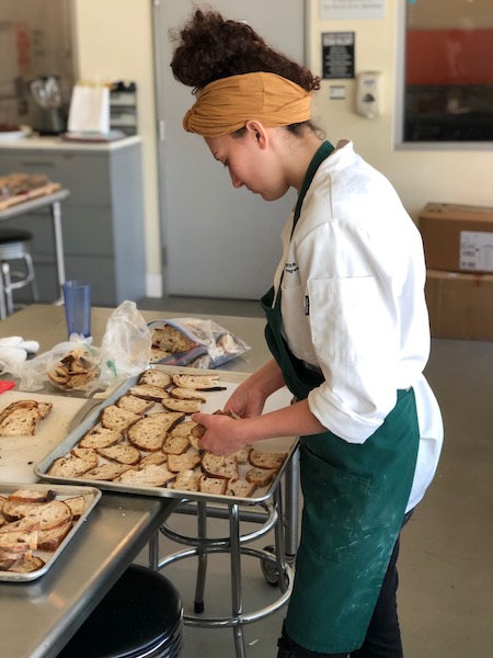 Female chef arranging bread