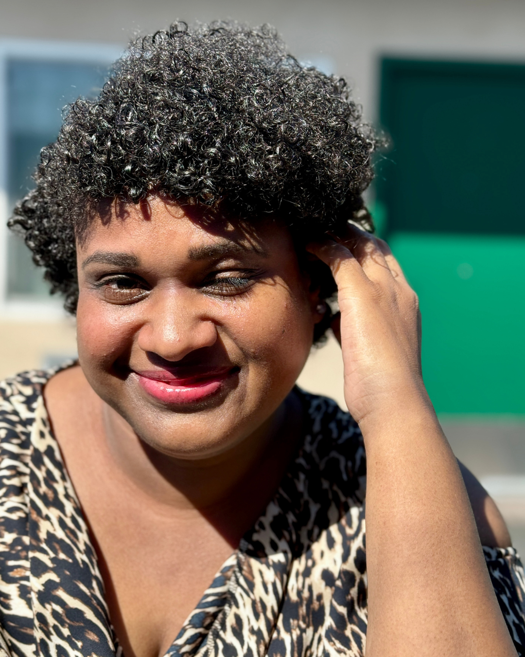 Cassie Patton smiling while seated outdoors.