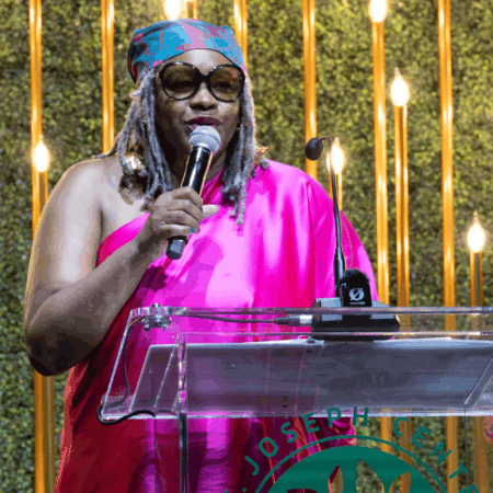 Suzette Shaw performing spoken word on stage at St. Joseph Center’s 2025 Gala.
