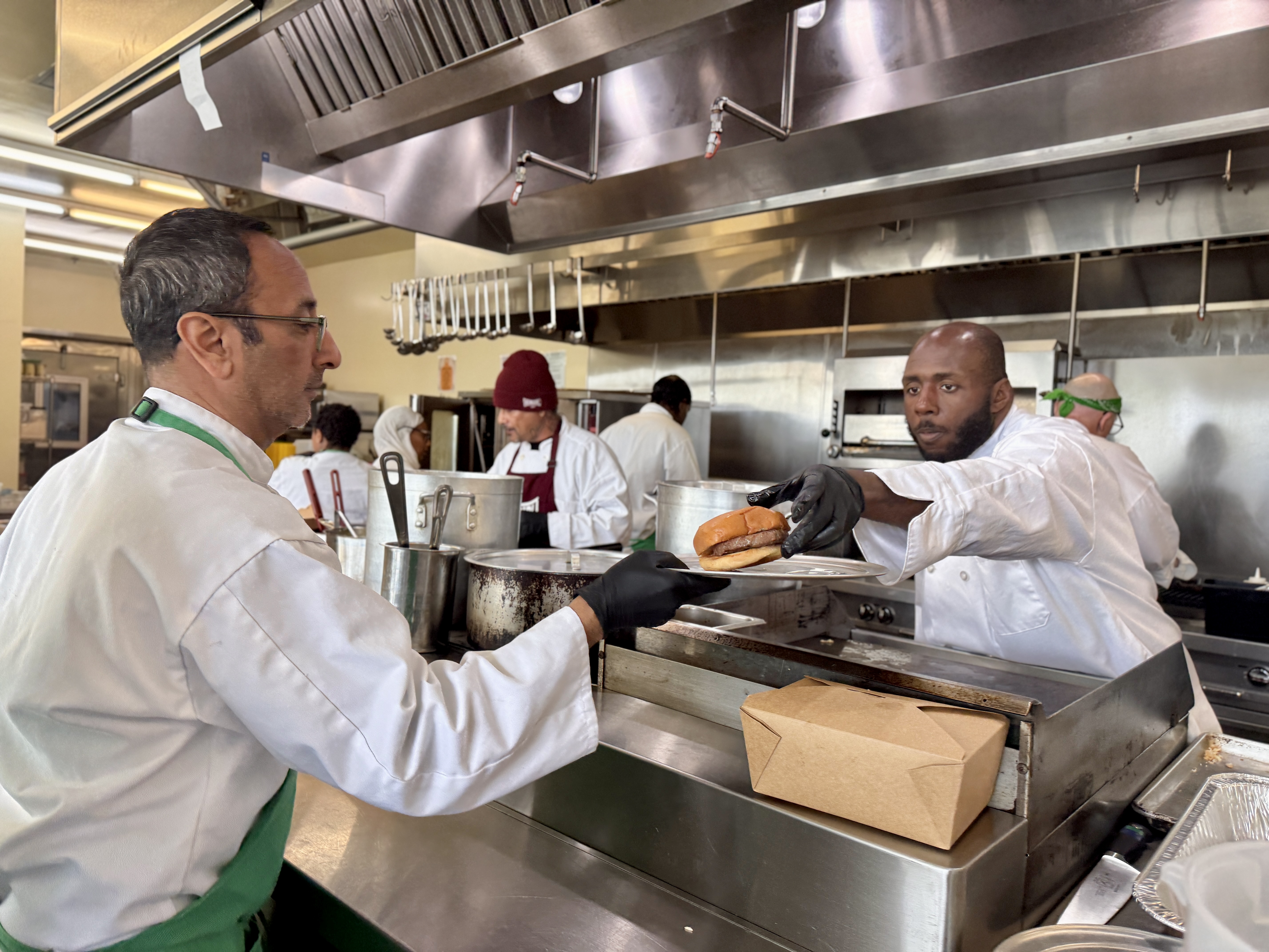 Team plating burgers during Bread & Roses training session.