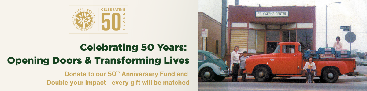 Historic photo of St. Joseph Center with red pickup truck and staff loading food outside the building.