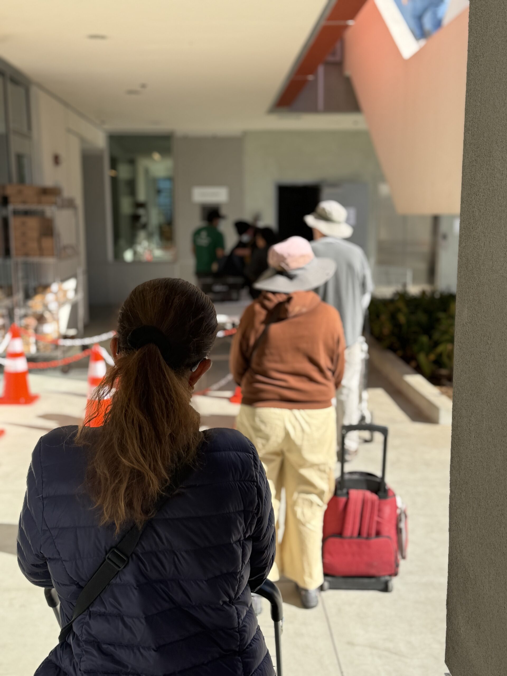 Community members lined up with carts waiting for groceries.