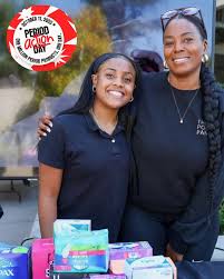 Amirah and Ashlee Turner at a donation table with period products during a community drive