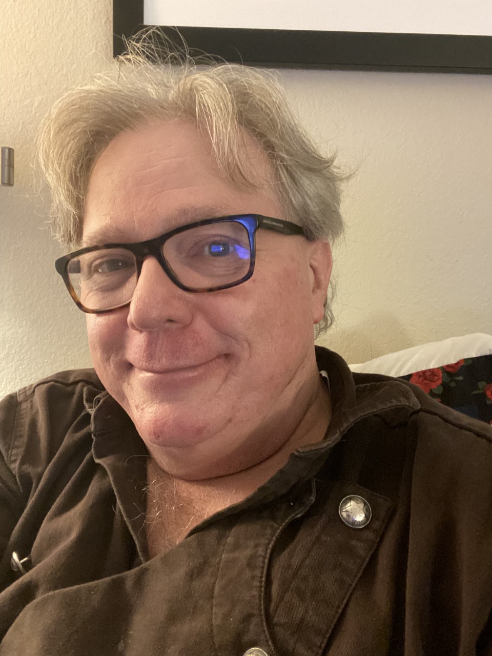 Marc Royston smiling in an indoor portrait.