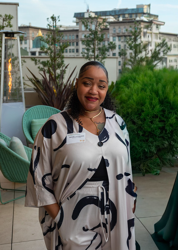 Rachel Gordon standing outdoors at a Los Angeles community event, reflecting her journey from homelessness to becoming a family advocate.