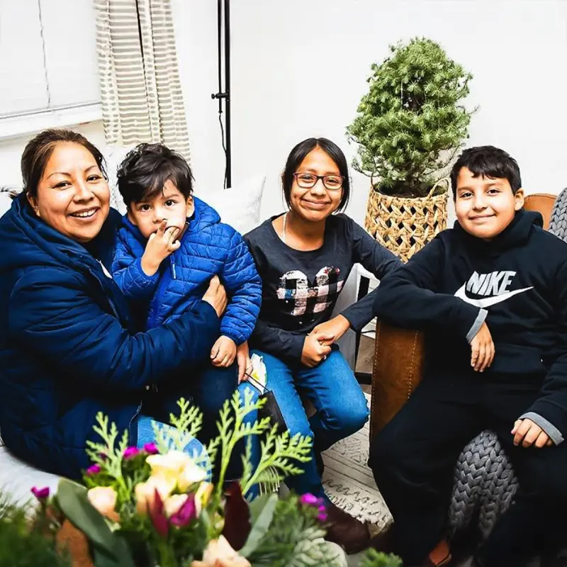sjc-family-sitting-in-living-room-housing