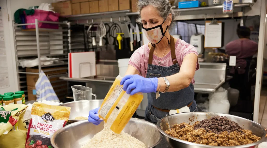 A volunteer baking bread at the Bread and Roses kitchen.