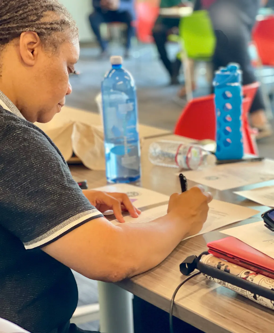 A woman filling out paperwork.