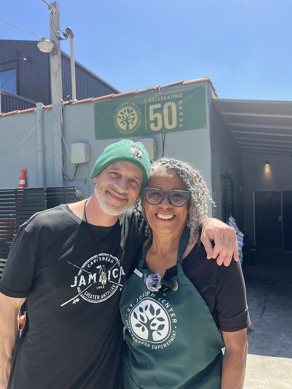 Yvette Coleman smiling with Chef James, Head Chef at Bread and Roses Café, outside St. Joseph Center
