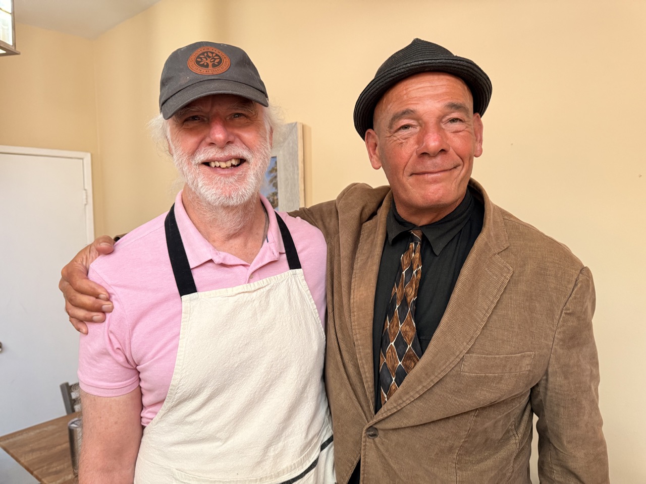 Deacon Kevin McCardle smiling with a community member at St. Joseph Center