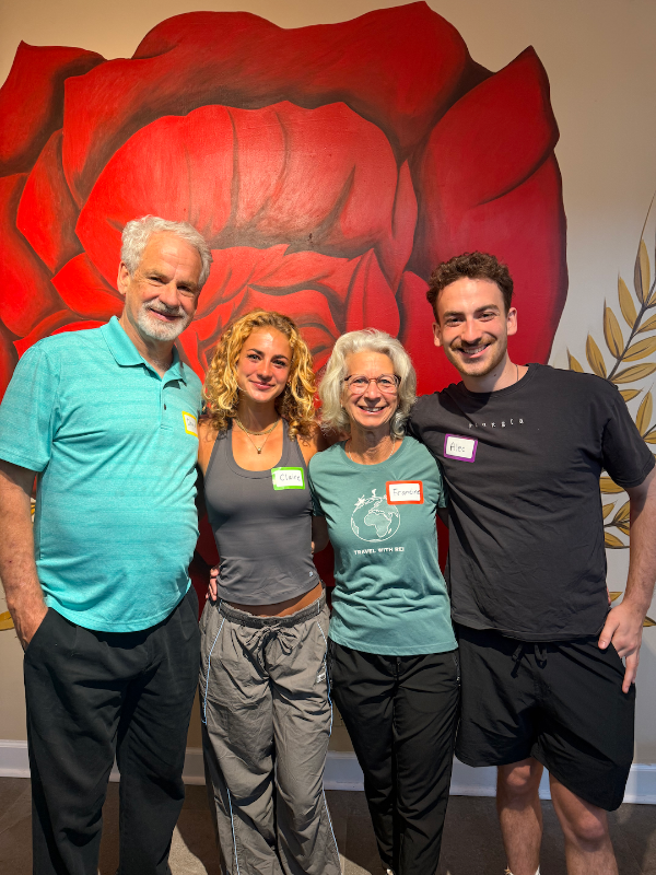 Claire standing with her mom, dad, and brother while volunteering at Bread and Roses Café