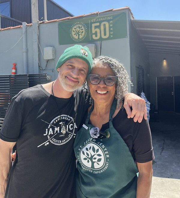 Bread & Roses Café volunteer Yvette standing with Chef James outside St. Joseph Center during the organization's 50th anniversary year.